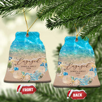 Personalized engagement Christmas ornament pair, bell shape with blue ocean beach and “Engaged” text.