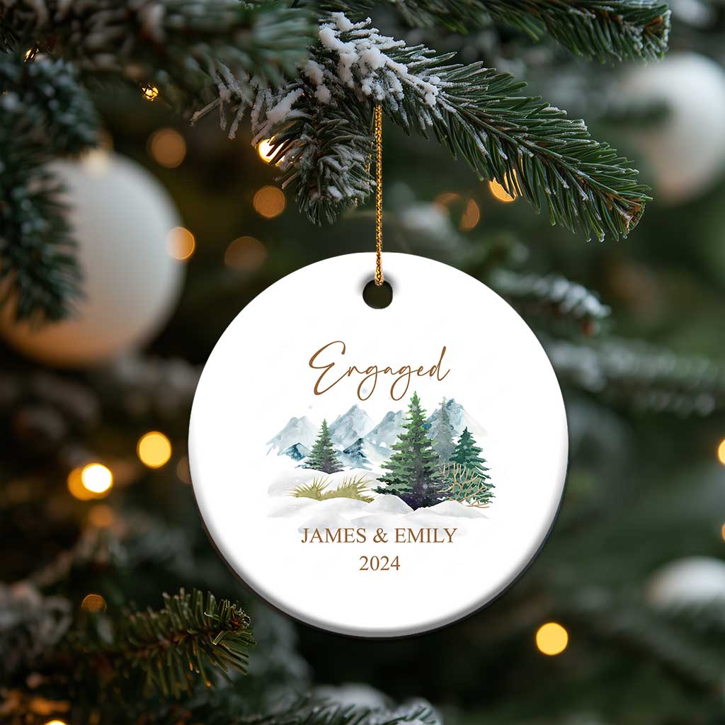 Engaged round Christmas ornament with gold string, snowy forest scene, JAMES & EMILY, 2024