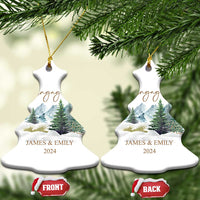 Engaged snowflake-shaped Christmas ornaments with gold strings, snowy forest, JAMES & EMILY, 2024