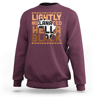 Maroon crewneck sweatshirt with orange/black 'Lightly Melanated Hella Black' graphic