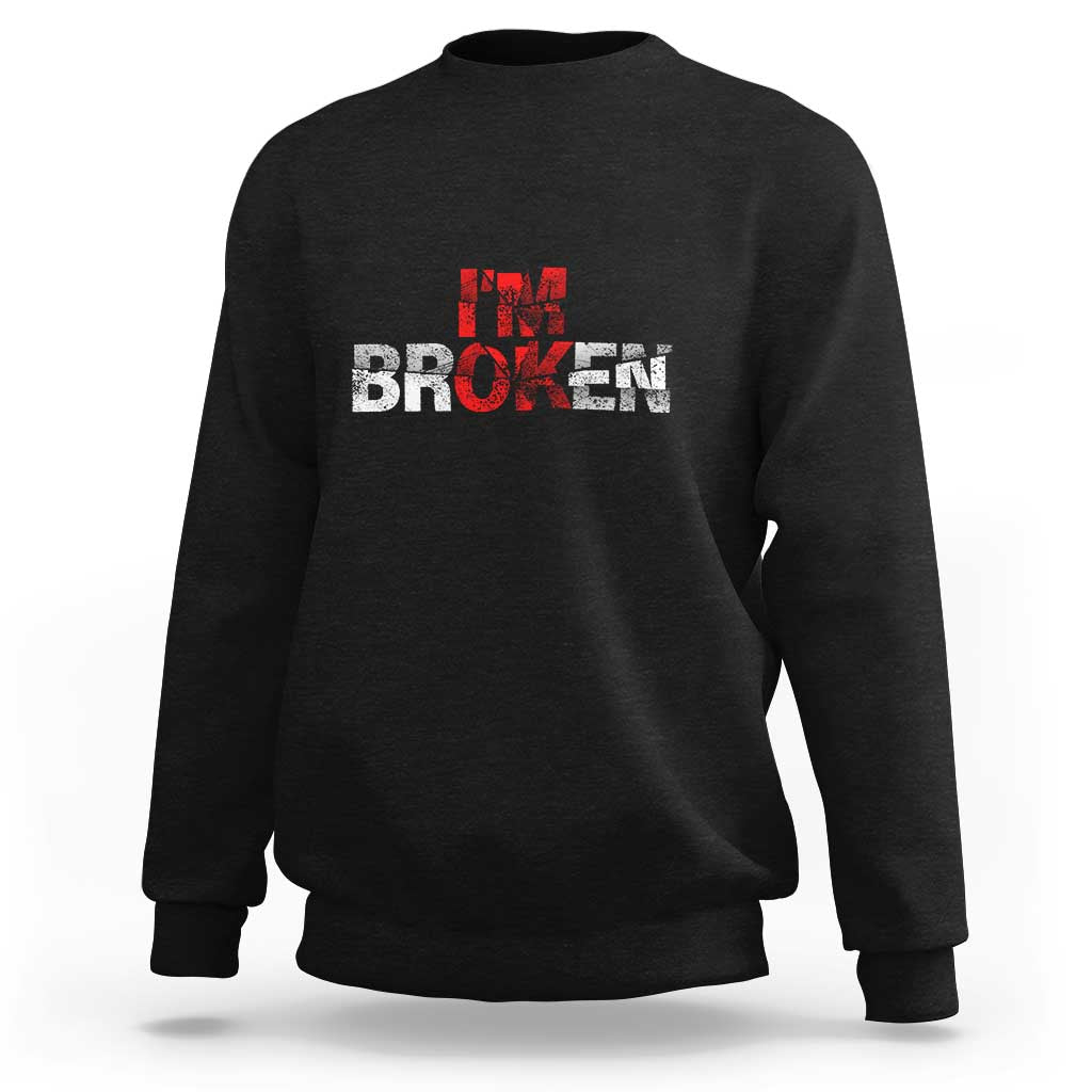 Black crewneck sweatshirt with “BROKEN” red-and-white graphic on front