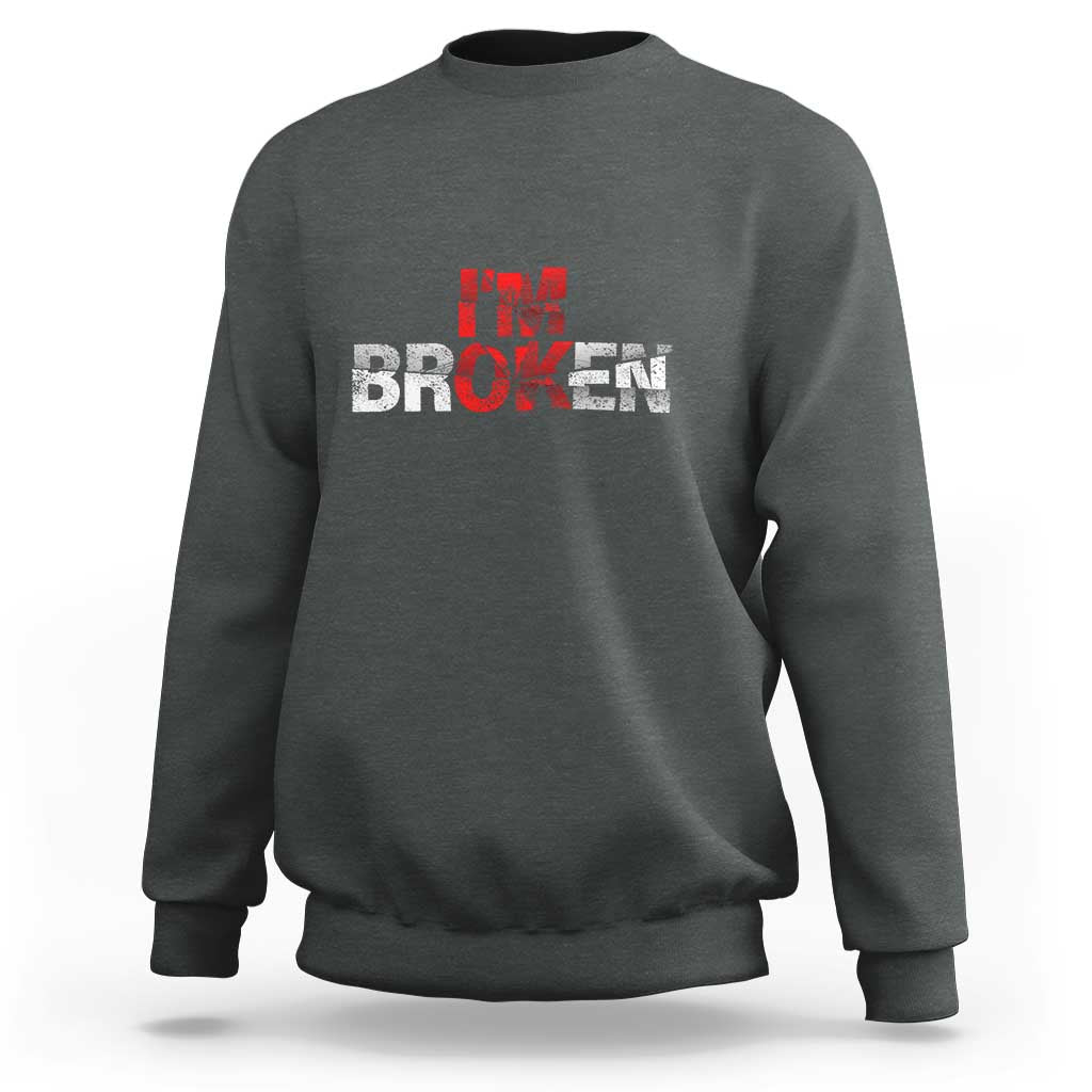 Charcoal gray crewneck sweatshirt with “BROKEN” red-and-white graphic on front