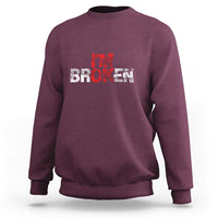 Maroon crewneck sweatshirt with “BROKEN” red-and-white graphic on front