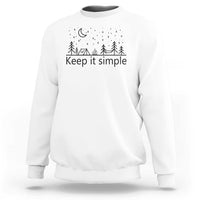 White crewneck sweatshirt with “Keep it simple” forest and moon graphic