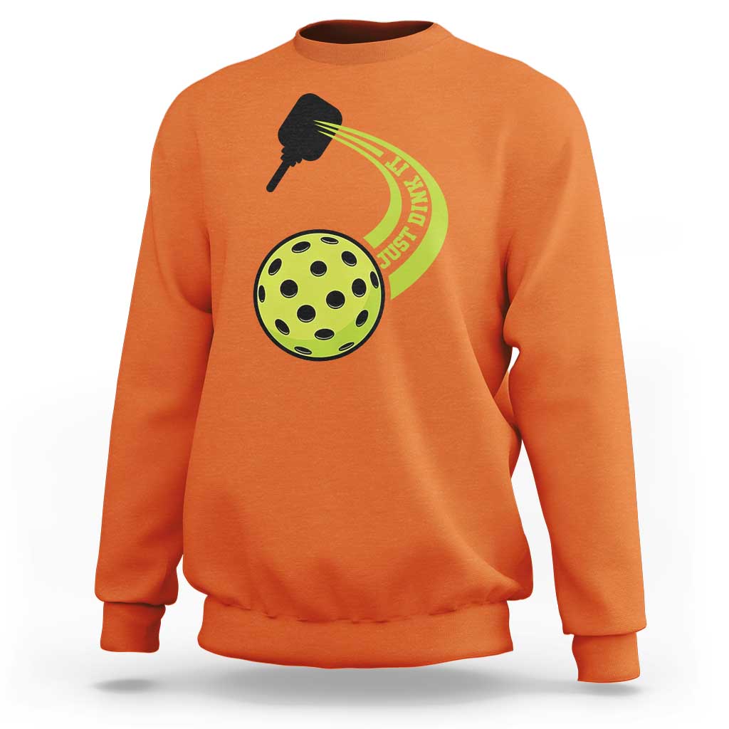 Orange sweatshirt with pickleball paddle and green pickle graphic on chest