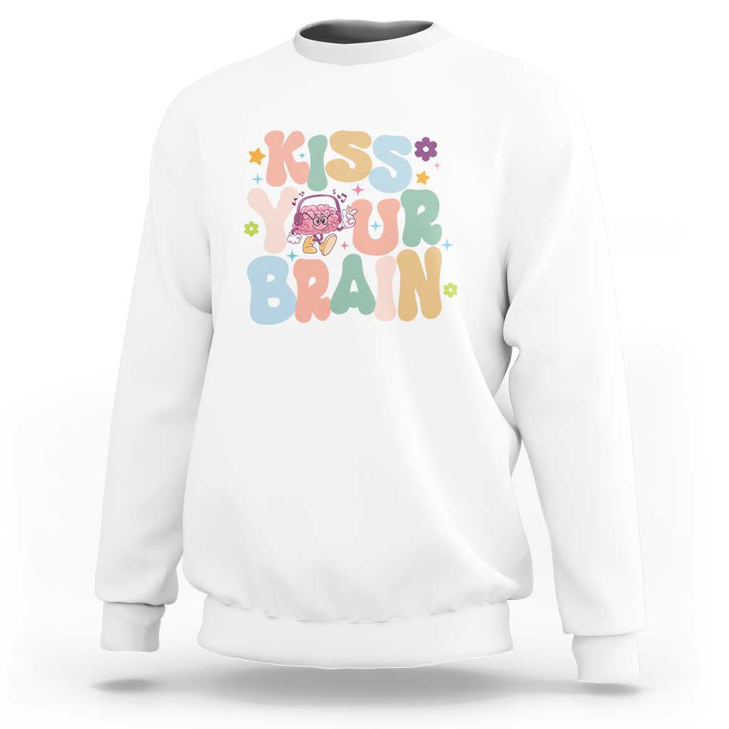 White crewneck sweatshirt with colorful “Kiss Your Brain” graphic and flower star accents