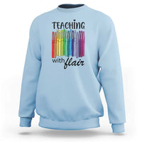 Light blue sweatshirt with “Teaching with Flair” pencil graphic, crewneck long sleeves.