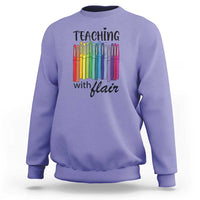 Violet sweatshirt with “Teaching with Flair” pencil graphic, crewneck long sleeves.