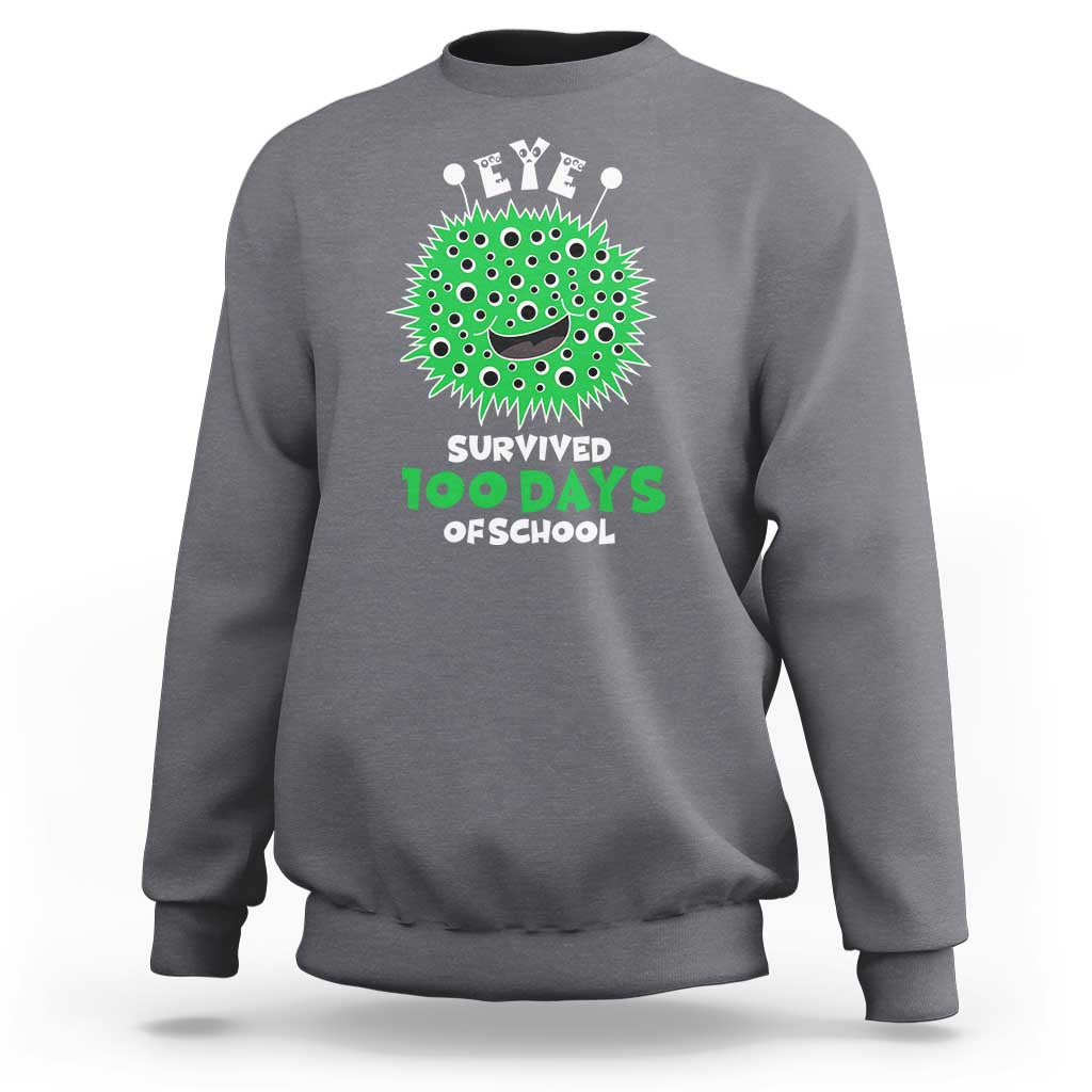 Dark heather gray crewneck sweatshirt with green monster eye graphic, “Survived 100 Days Offschool”