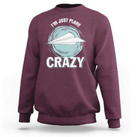 Maroon crewneck sweatshirt with front plane graphic and 'CRAZY' text, long sleeves