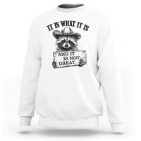 White raccoon sweatshirt with black quote text and raccoon hand graphic