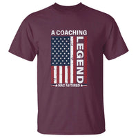 Maroon graphic T-shirt with retired American flag and coaching text, crew neck