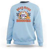 Light blue sweatshirt with a cute ghost reading a book graphic, "READ MORE" and "BOOOOOKS".