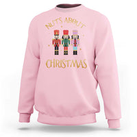 Light pink crewneck Christmas nutcracker sweatshirt with “Nuts About Christmas” graphic
