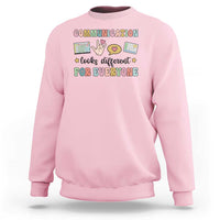 Light pink crewneck graphic sweatshirt with colorful “Communication for everyone” text design