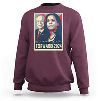Maroon sweatshirt with “FORWARD 2024” portrait graphic on the back
