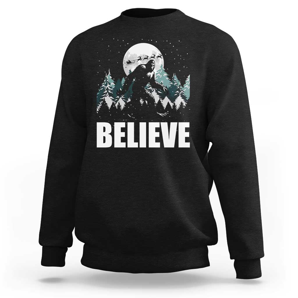 Black crewneck sweatshirt with Bigfoot 'BELIEVE' graphic and pine trees