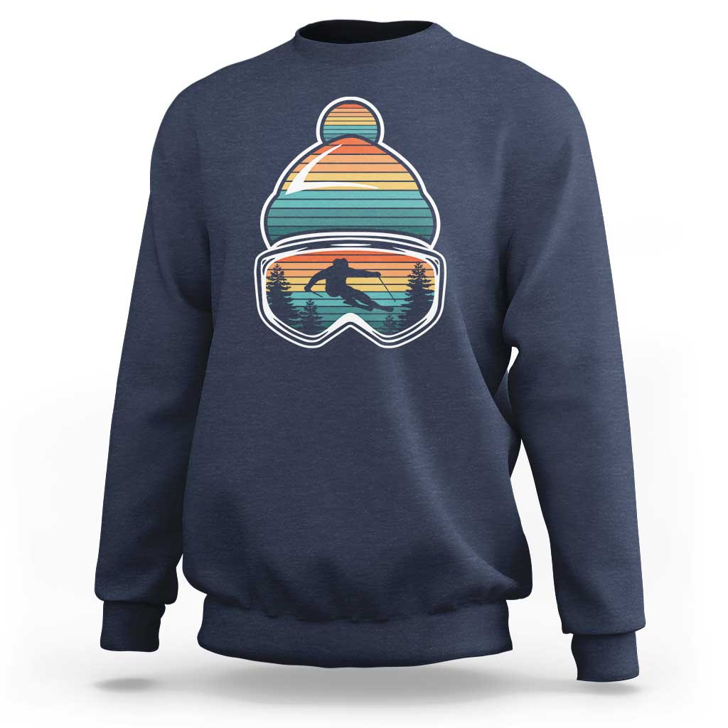 Ski-themed crewneck sweatshirt in navy blue with retro mountain goggles graphic on chest
