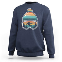 Ski-themed crewneck sweatshirt in navy blue with retro mountain goggles graphic on chest