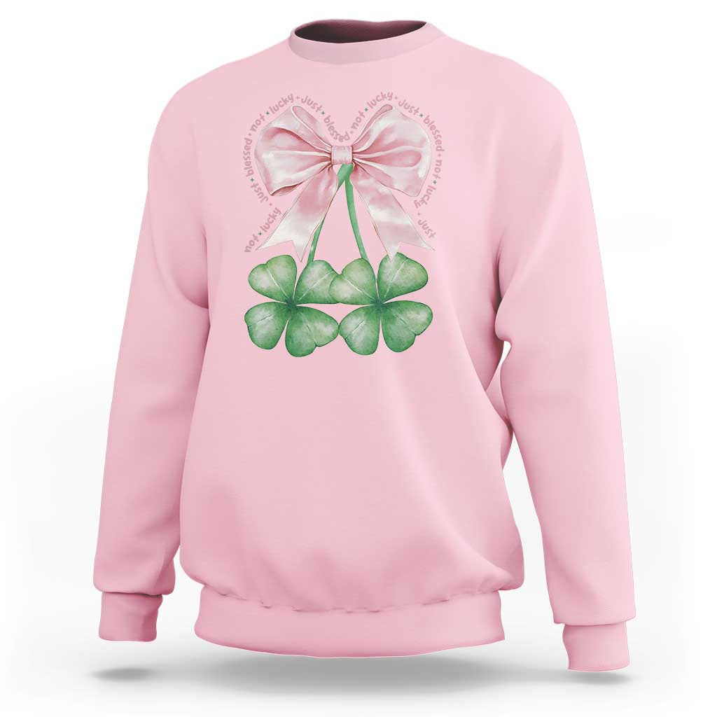Light pink sweatshirt with pink bow and four-leaf clover shamrock graphic on front