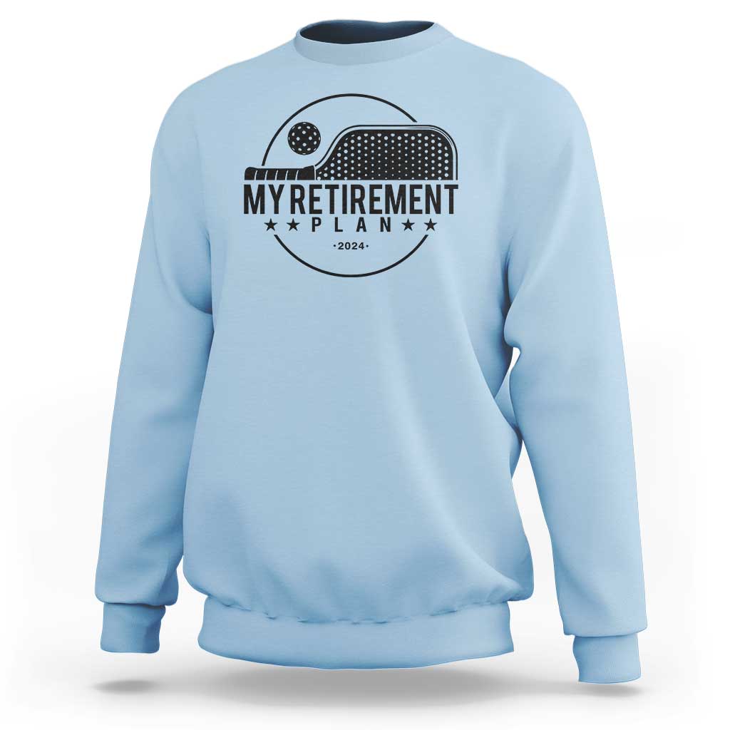 Light blue crewneck sweatshirt with pickleball paddle graphic and 'Retirement Plan 2024' text
