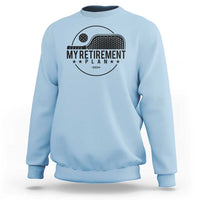 Light blue crewneck sweatshirt with pickleball paddle graphic and 'Retirement Plan 2024' text