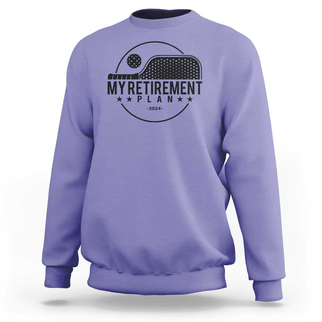 Violet crewneck sweatshirt with pickleball paddle graphic and 'Retirement Plan 2024' text