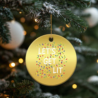 Gold round Christmas ornament hanging from a tree branch, “LET’S GET LIT” with light icons