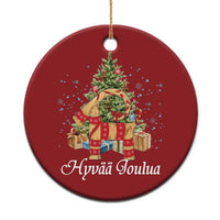 Round red Christmas ornament with tree, gift boxes, and Yule goat design