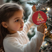 Red round Christmas ornament with tree and Hyvää joulua print