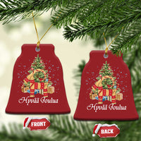 Red bell-shaped Christmas ornament, front and back, with tree graphic and Hyvää Joulua text
