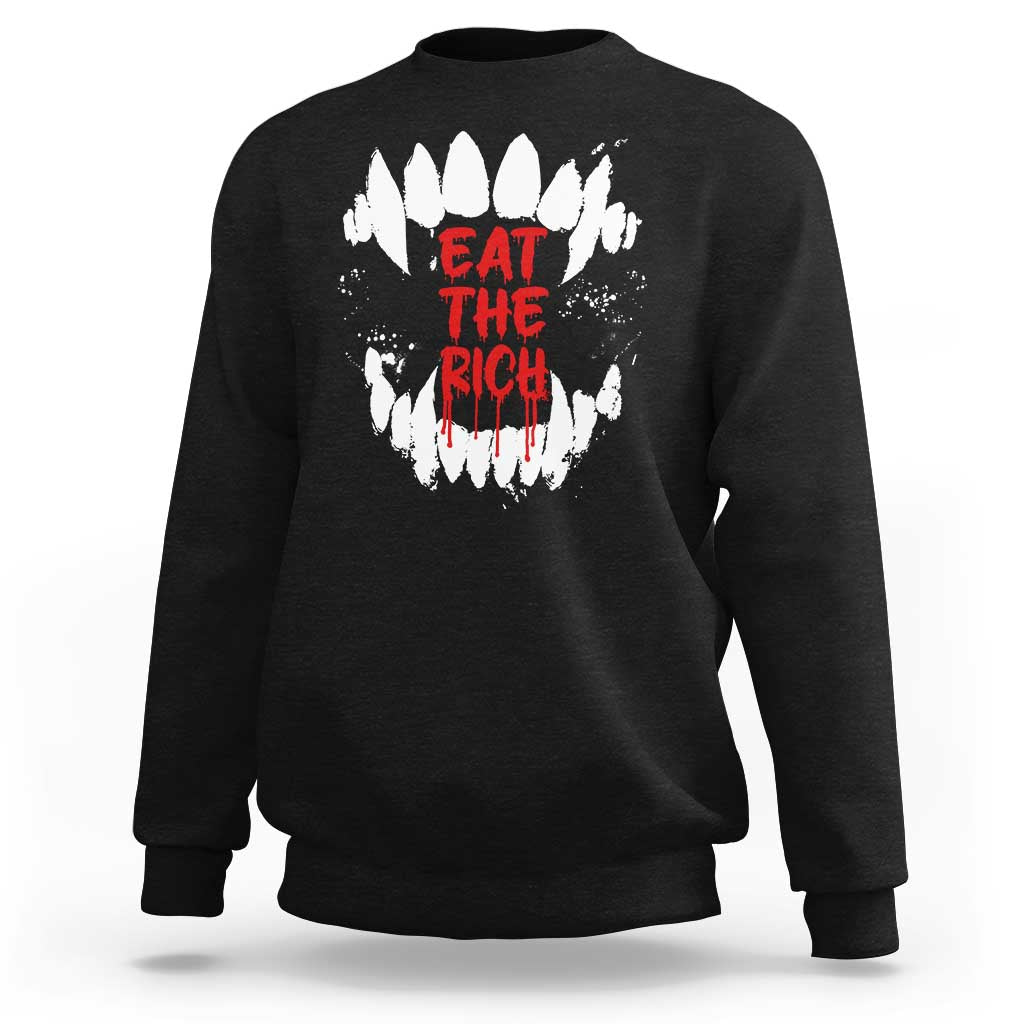 Black sweatshirt with white fang graphic and red “EAT THE RICH” text on back
