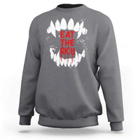 Charcoal sweatshirt with white fang graphic and red “EAT THE RICH” text on back