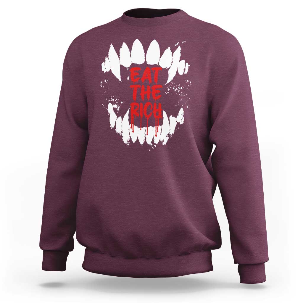 Maroon sweatshirt with white fang graphic and red “EAT THE RICH” text on back