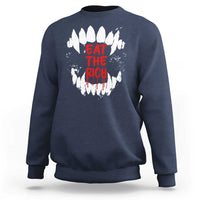 Navy sweatshirt with white fang graphic and red “EAT THE RICH” text on back