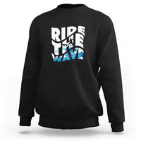 Black surfing sweatshirt with “Ride the Wave” graphic on the chest