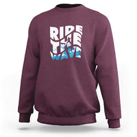 Maroon surfing sweatshirt with “Ride the Wave” graphic on the chest