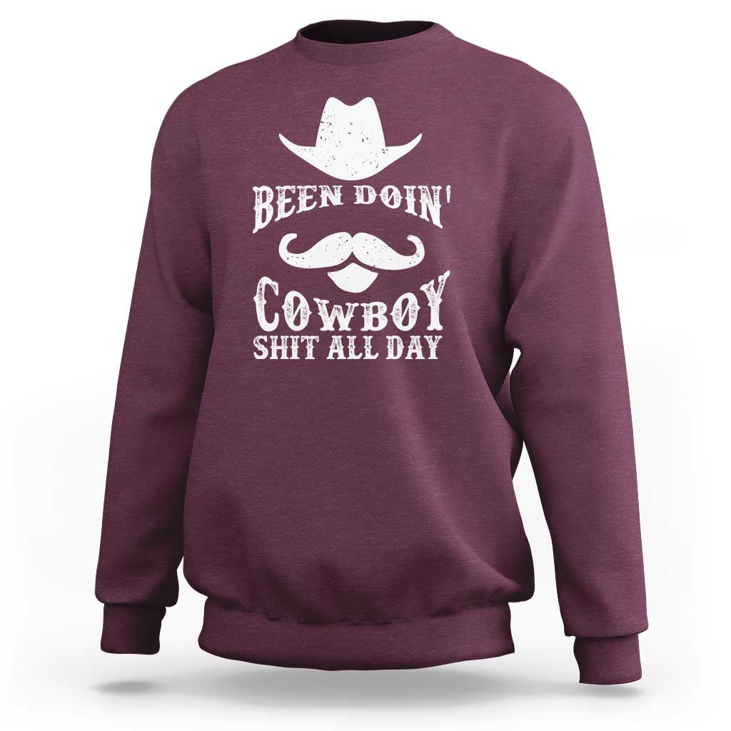 Maroon cowboy sweatshirt with white graphic: Been Doin' Cowboy Shit All Day