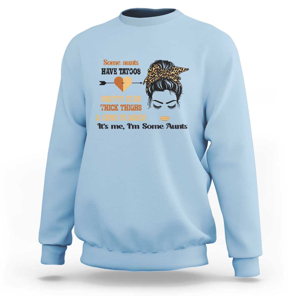 Light blue sweatshirt with front graphic of tattoo heart, woman face, and text