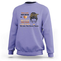 Violet sweatshirt with front graphic of tattoo heart, woman face, and text