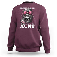 Maroon crewneck sweatshirt with skull and pink bow graphic reading “AUNT”