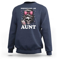 Navy crewneck sweatshirt with skull and pink bow graphic reading “AUNT”