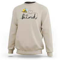 Sand crewneck sweatshirt with bee and heart 'kind' graphic.