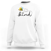 White crewneck sweatshirt with bee and heart 'kind' graphic.