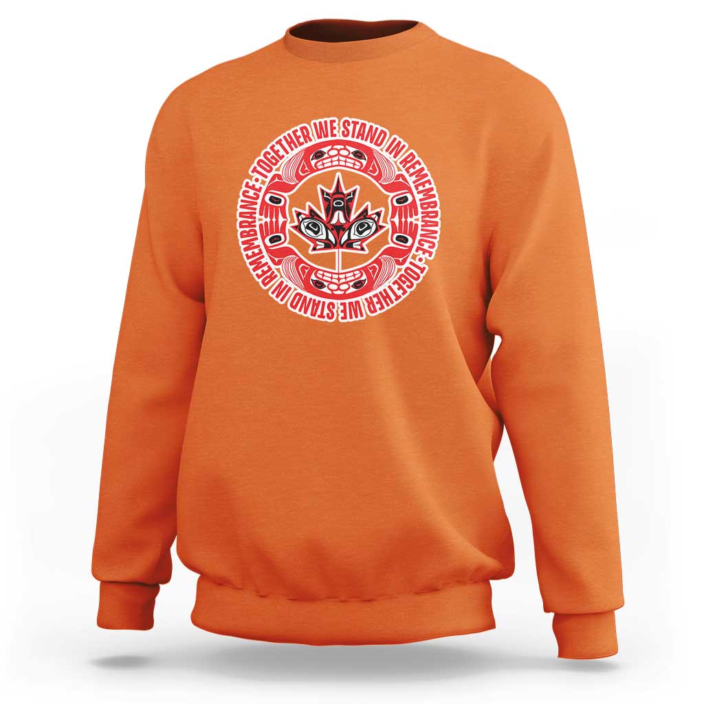 Kids orange crewneck sweatshirt with red circular remembrance graphic on chest