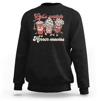 Black crewneck sweatshirt with red “Let’s watch Horror movies” graphic on front