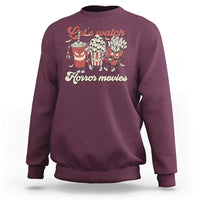 Maroon crewneck sweatshirt with red “Let’s watch Horror movies” graphic on front