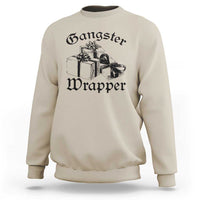 Sand crewneck Christmas sweatshirt with “Gangster Wrapper” graphic and gift boxes