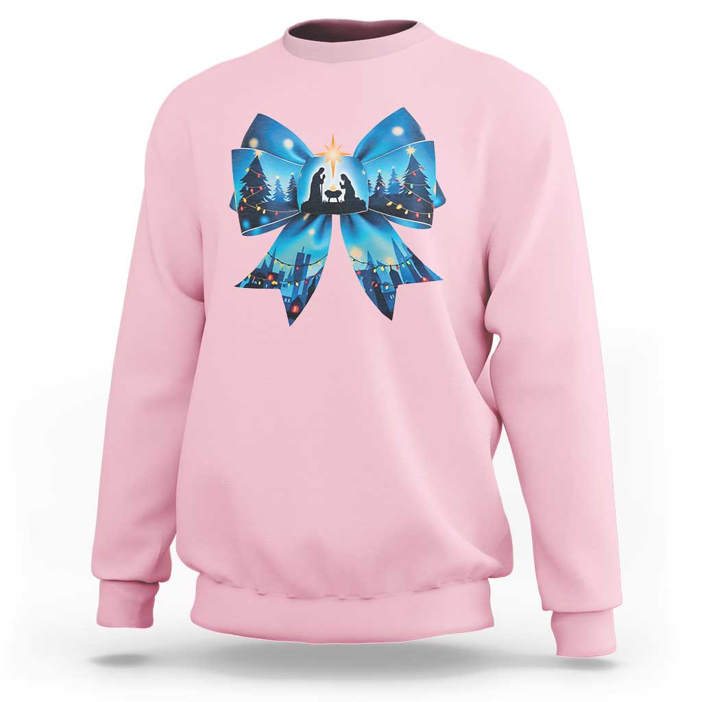 Light pink Christmas sweatshirt with blue bow graphic and nativity scene front print