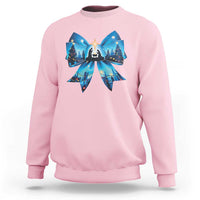 Light pink Christmas sweatshirt with blue bow graphic and nativity scene front print